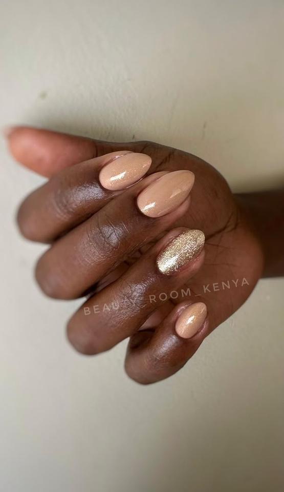 Nude manicure with a gold glitter accent nail, done at Beauty Room Kenya