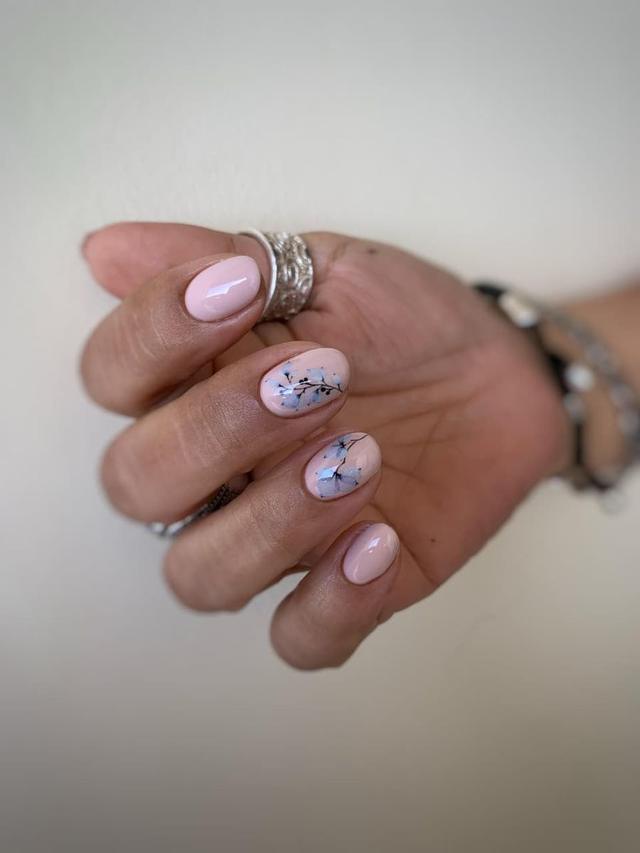 Blush manicure with blue floral accents