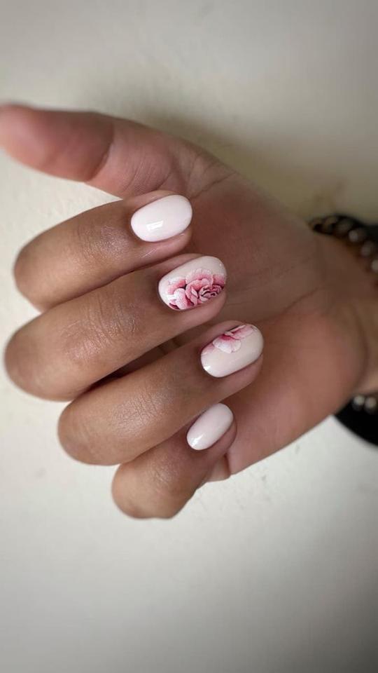 Milky pink manicure with rose accent